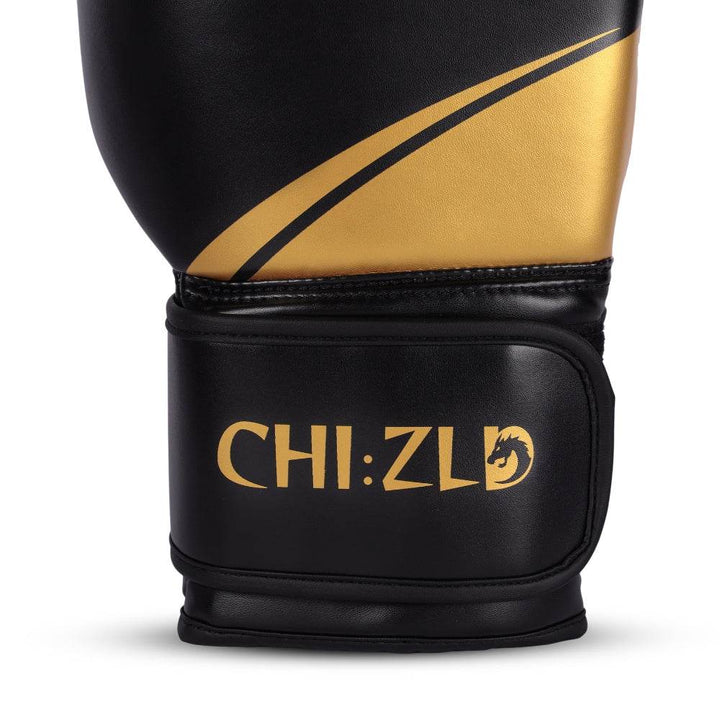Close-up of outer wrist area showing gold swoosh detail and raised CHIZLD logo printed on black strap.