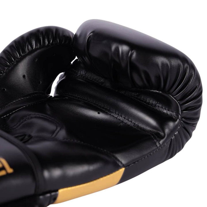 Interior palm shot displaying curved grip bar, perforations for airflow, and dense ergonomic padding along thumb seam.