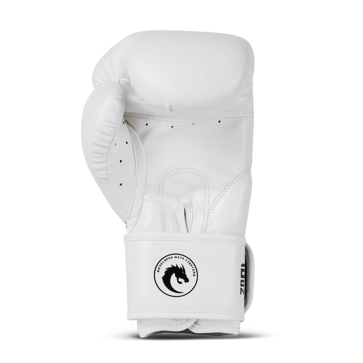 Rear (palm) view: smooth white synthetic-leather with stitched grip bar, ventilated finger gussets, and circular black dragon badge on wrist cuff (12 oz).