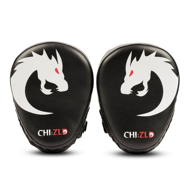 Front view of the pair of black CHIZLD curved focus mitts featuring large white dragon-head logo with red eye on each striking surface.