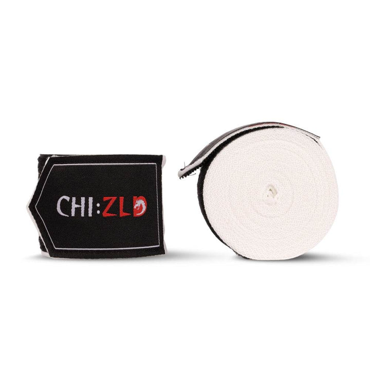 Two 4.5 m CHIZLD Impact handwraps: one neatly rolled white wrap, one folded section displaying black patch with white “CHI:” and red “ZLD” logo framed by white edging.