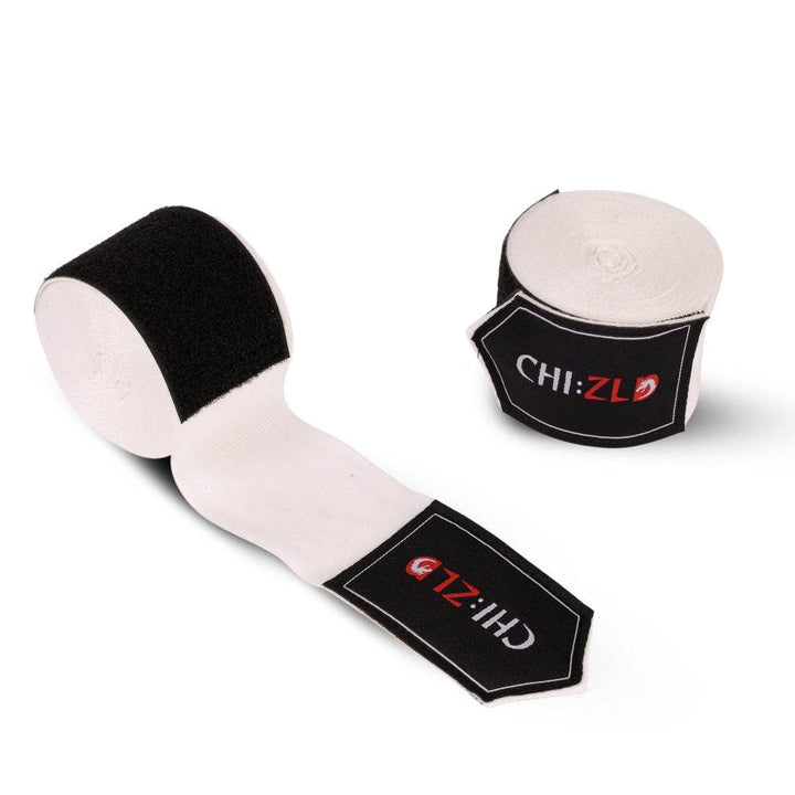 Pair of wraps on white background: one full roll, one half-unrolled to show white elastic band and oversized black Velcro strip.
