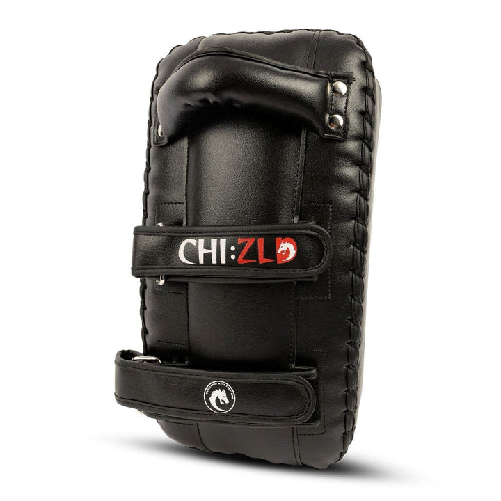 Rear of pad close-up: ergonomic top handle, metal rivets, and dual forearm straps for secure fit, all in black leatherette.