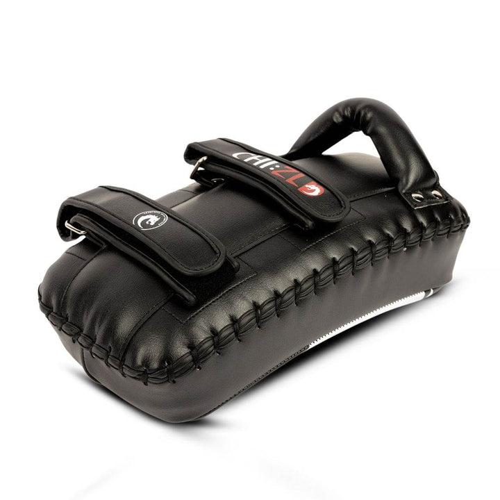 Low-angle shot of pad laying flat, showing reinforced side lacing, contoured padding, and underside ventilation panel.