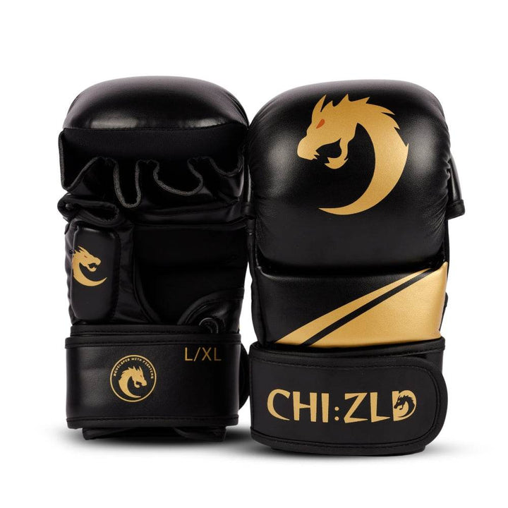 Front view of paired black and gold MMA-style sparring gloves with padded knuckle shell, godl dragon-head logo, and diagonal golden accent stripe.