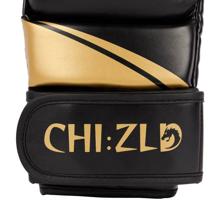 Detail of wrist closure showing curved golden swoosh above wide black hook-and-loop strap printed with CHIZLD word-mark.