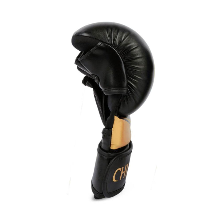 Narrow side profile of a single glove illustrating pre-curved fist shape and compact striking surface.
