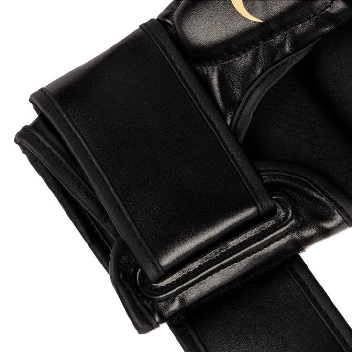 Macro of plain strap end, showing clean black synthetic leather and reinforced stitching along the edges.