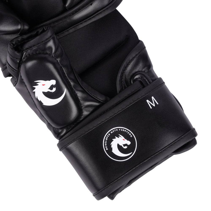 Close-up of wrist cinch highlighting circular “Developed with Fighters” dragon emblem and size “M” indicator.