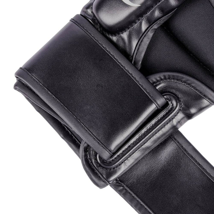 Macro of plain strap end, showing clean black synthetic leather and reinforced stitching along the edges.
