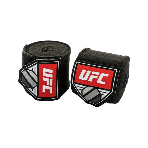Pair of rolled UFC 4.5 m hand wraps in solid black cotton-blend fabric; bold red-and-white UFC shield logo patch displayed on each roll.	