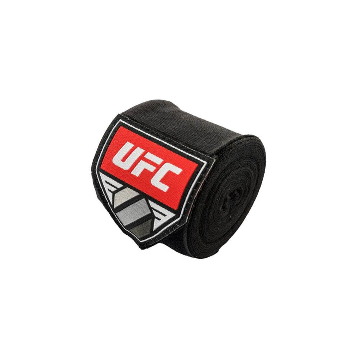 One tightly rolled black wrap photographed at an angle, highlighting the red UFC shield label against the dark fabric.	