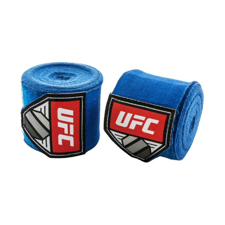 Two rolls of UFC hand wraps in deep royal-blue fabric with the same red UFC shield patches front-facing.