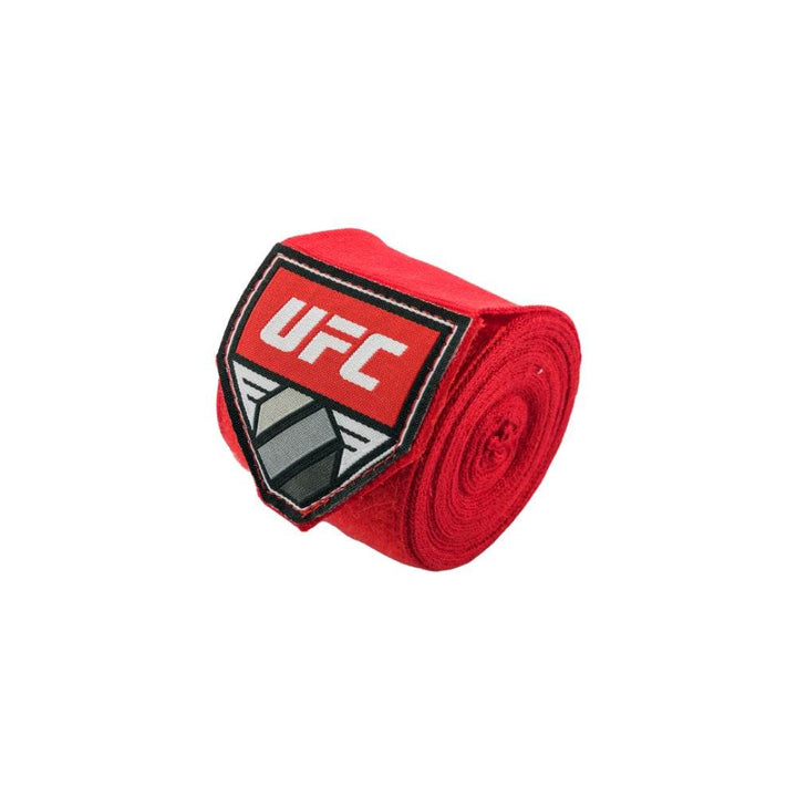 Single red hand-wrap roll photographed at an angle, emphasising the logo patch and dense roll.