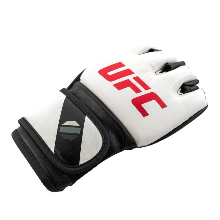 Three-quarter shot of glove lying flat; red branding, black diagonal accent and octagon emblem pop against white background.