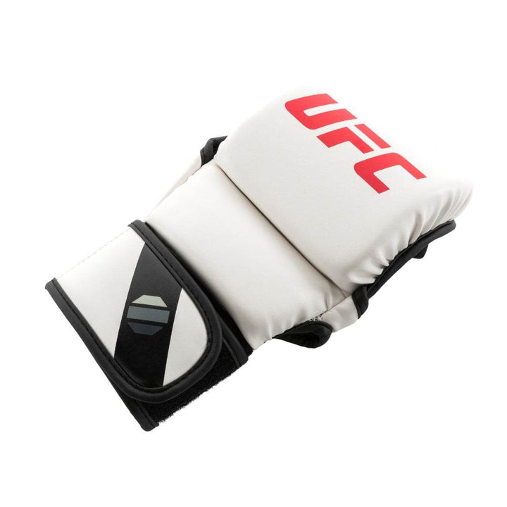 Angled hero – Glove resting at ¾ angle; stacked white segments, red logo and black diagonal wrist graphic stand out against minimalist colourway.