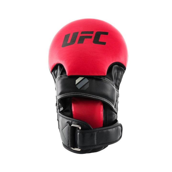Glove side (coach view) – Red domed palm hood carrying black “UFC” word-mark; black leather hand channel beneath with adjustable wrist strap and small grey octagon target.