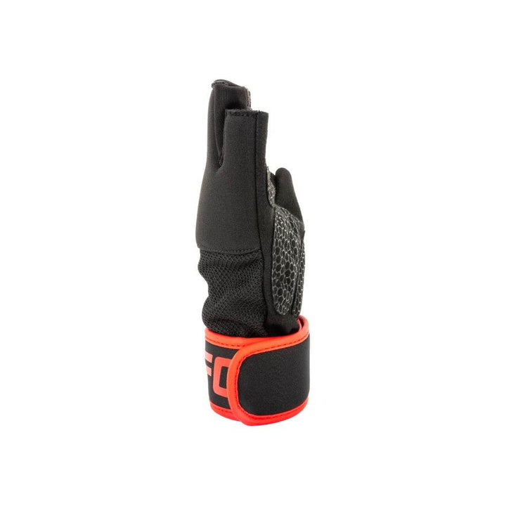 Side profile – little-finger side: Opposite edge view of glove, revealing curved palm padding profile and wrapped wrist strap with red trim and UFC logo partially visible.