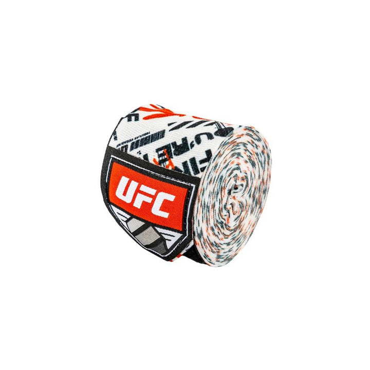 One roll of the graffiti-pattern wrap photographed at an angle, showing the densely rolled fabric and the red UFC shield label patch.