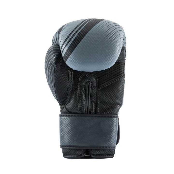 Rear view of a single black UFC Performance Rush boxing glove standing upright, displaying its textured synthetic-leather shell and a grey diagonal stripe across the padded knuckle, with a wide hook-and-loop wrist strap fastened at the bottom.