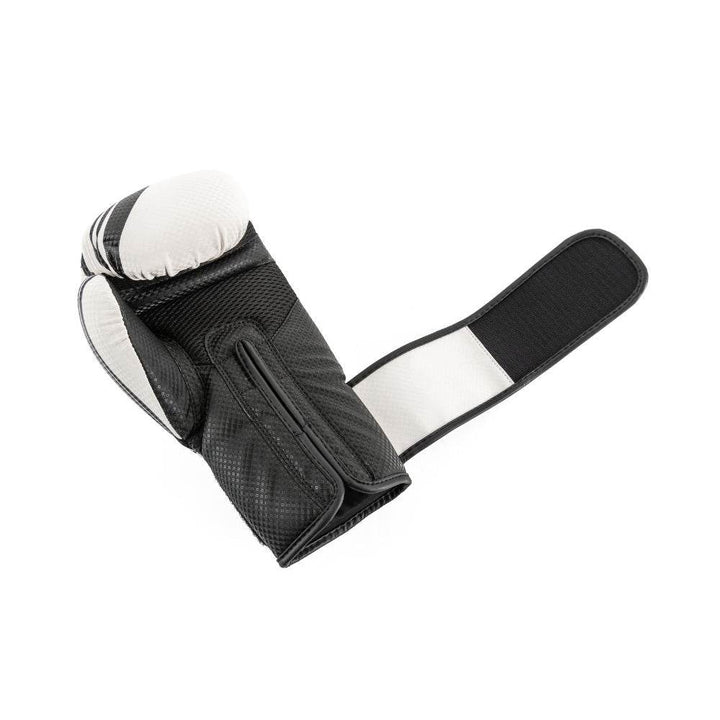 Palm-side view of a white-and-black UFC Performance Rush boxing glove laid open with the black hook-and-loop strap fully extended, revealing the ventilated mesh palm panel, padded thumb channel, and interior lining.
