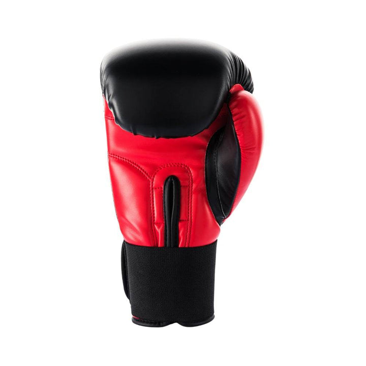 Rear (palm-side) view of a red-and-black UFC Pro Compact bag glove, highlighting the ventilated black palm mesh, contoured thumb guard, and padded red wrist cuff with secure hook-and-loop strap.