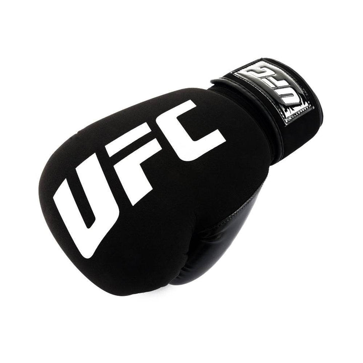 Angled overhead shot of the glove in “fist” position, emphasizing the rounded knuckle area with white “UFC” logo and secure wrist strap.