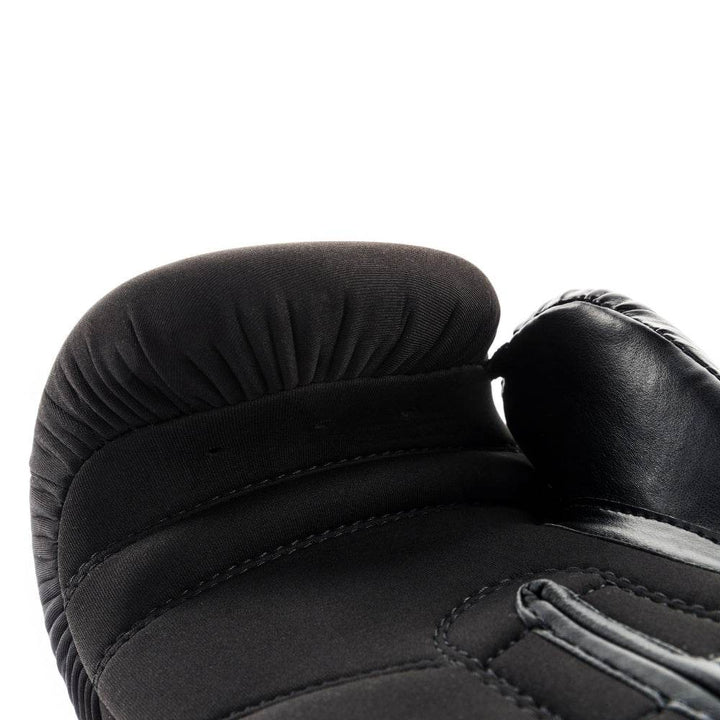 Macro image of the inside knuckle area focusing on the gathered fabric, finger-bar seam and layered foam padding.