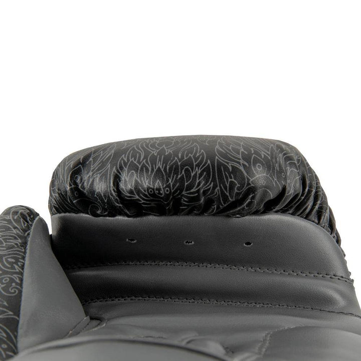 Palm-side view of a black UFC Thai Naga boxing glove revealing the ventilated black mesh palm panel and padded thumb channel.