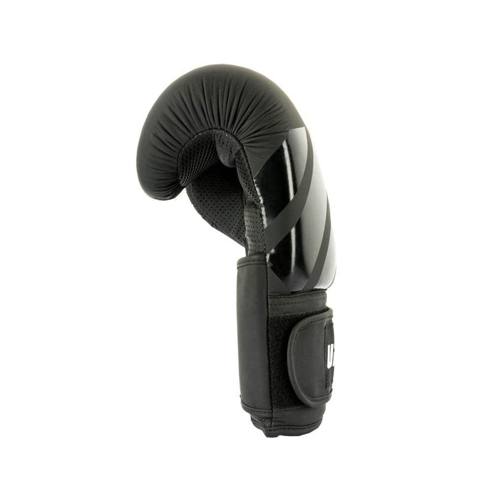 Glove on edge highlighting multi-layer knuckle padding tapering toward wrist; thumb attachment curve visible.