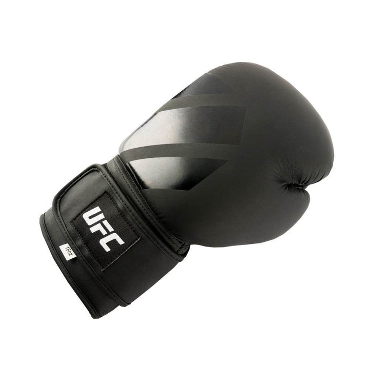 Three-quarter angle with strap partly open; tonal octagon icon printed on end tab and box-stitched anchor patch.