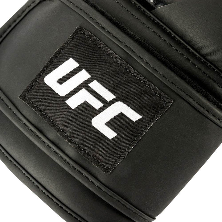 Tight close up of the cuff at the wrist with white UFC logo.