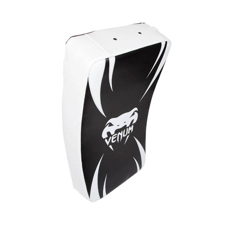 Angled perspective of the Venum Absolute Long Kick Shield highlighting its contoured design and bold snake logo on a black and white surface.