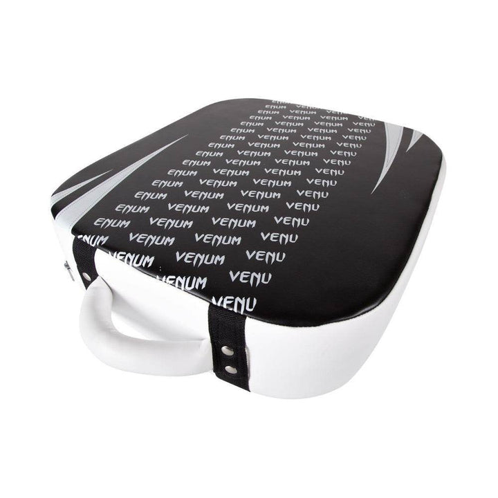 Angled shot of the kick shield showing repeating “Venum” branding on striking surface and side handle.