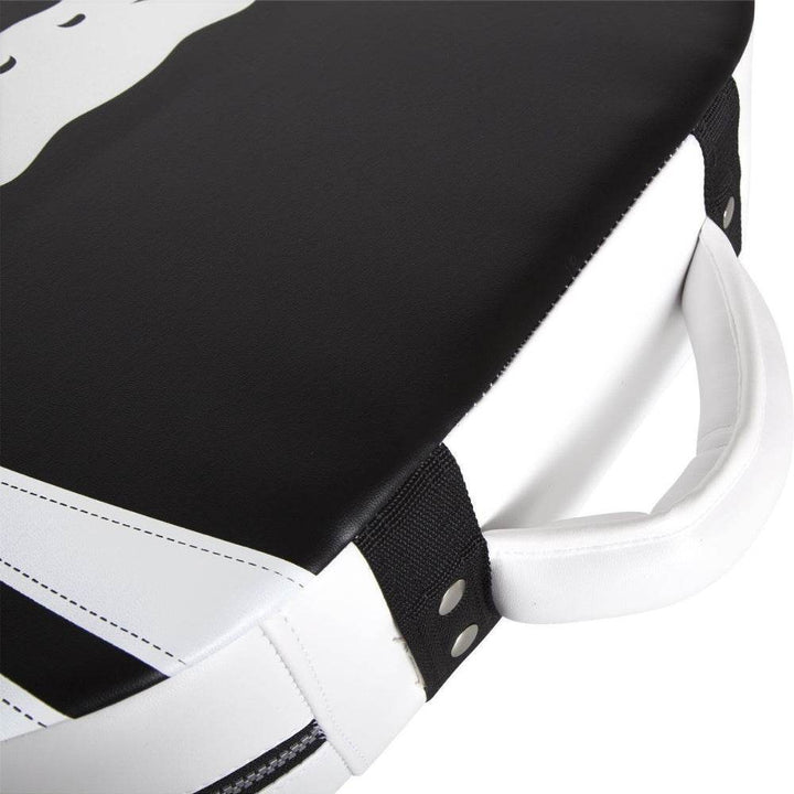 Close-up of shield's corner showing thick black and white synthetic leather and reinforced rivets.