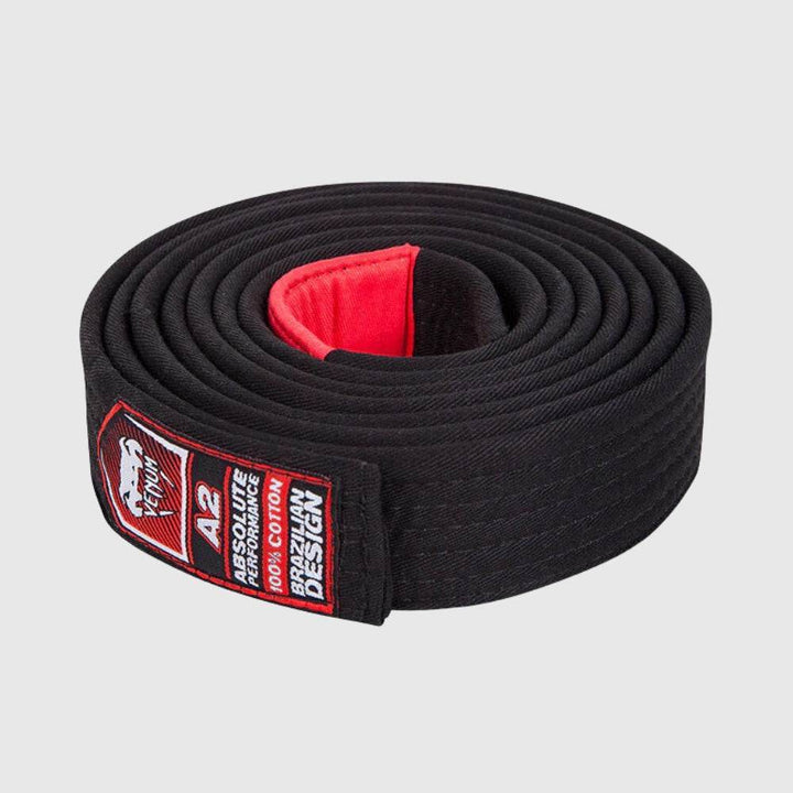 Rolled Venum Brazilian Jiu-Jitsu black belt featuring a red interior patch and a red label displaying size A2 and Brazilian design branding.