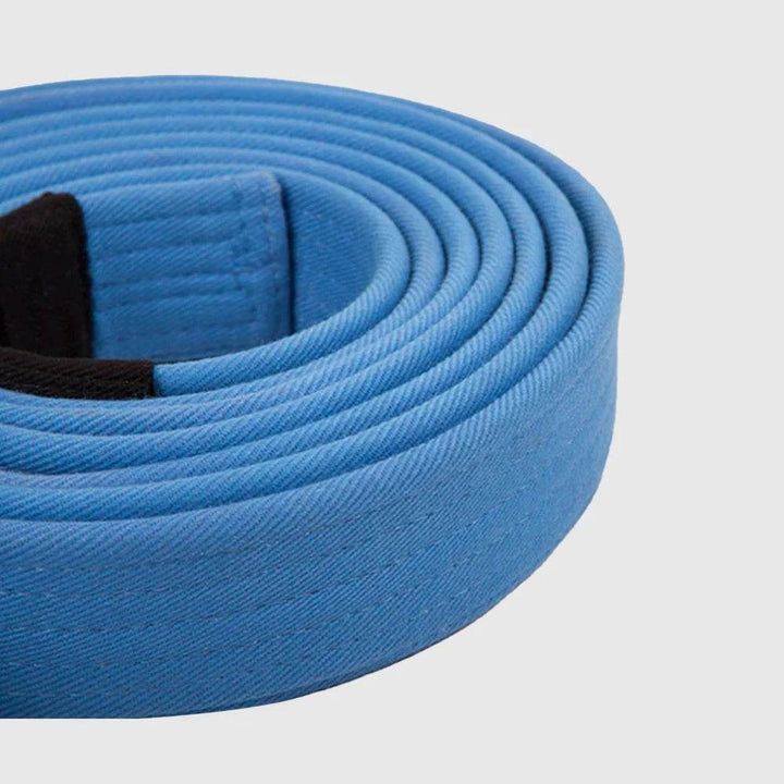 Side close-up of the Venum BJJ blue belt showcasing its textured cotton build and color.