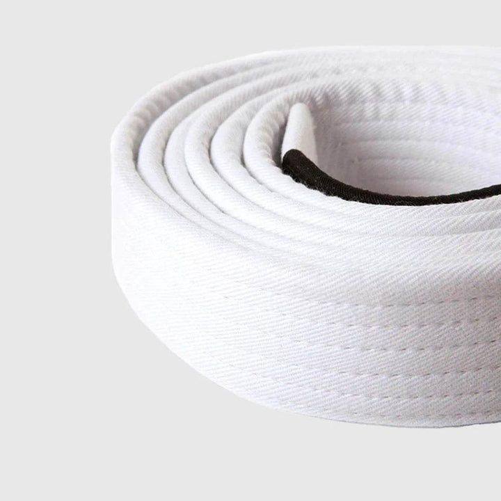 Close-up of the rolled Venum BJJ white belt, highlighting its textured cotton fabric and black patch.