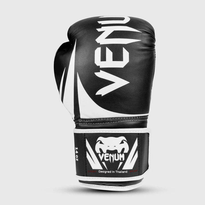 Isolated front view of a single glove, highlighting the large vertical Venum logo, dynamic graphic swooshes, and sturdy wrist support.
