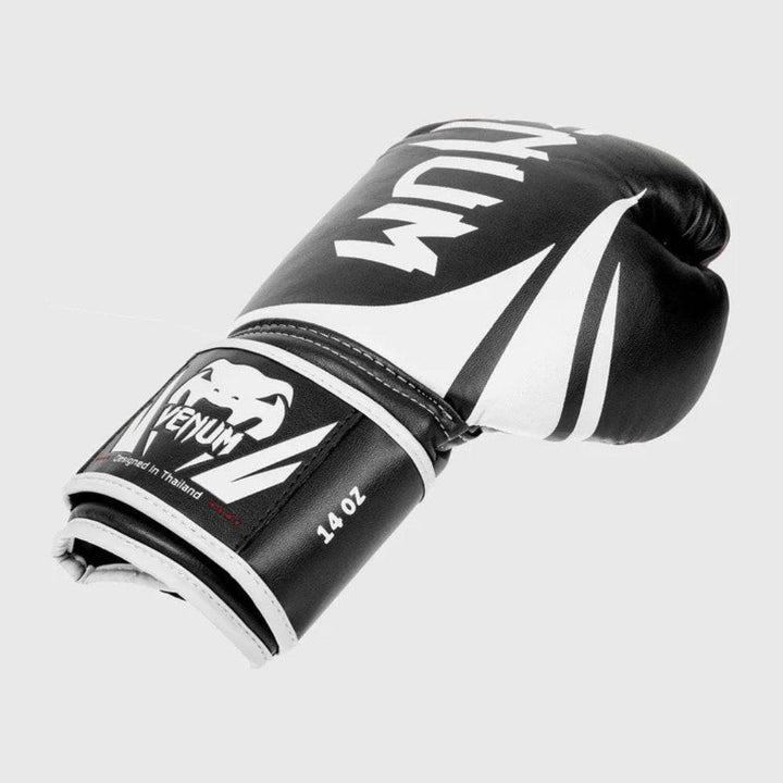 Angled view of a single glove showing the outer surface design, Velcro closure system, and 14 OZ weight indicator near the cuff.