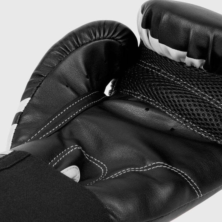Detailed palm-side shot of the glove with visible grip bar, stitched padding channels, and high-density foam lining.