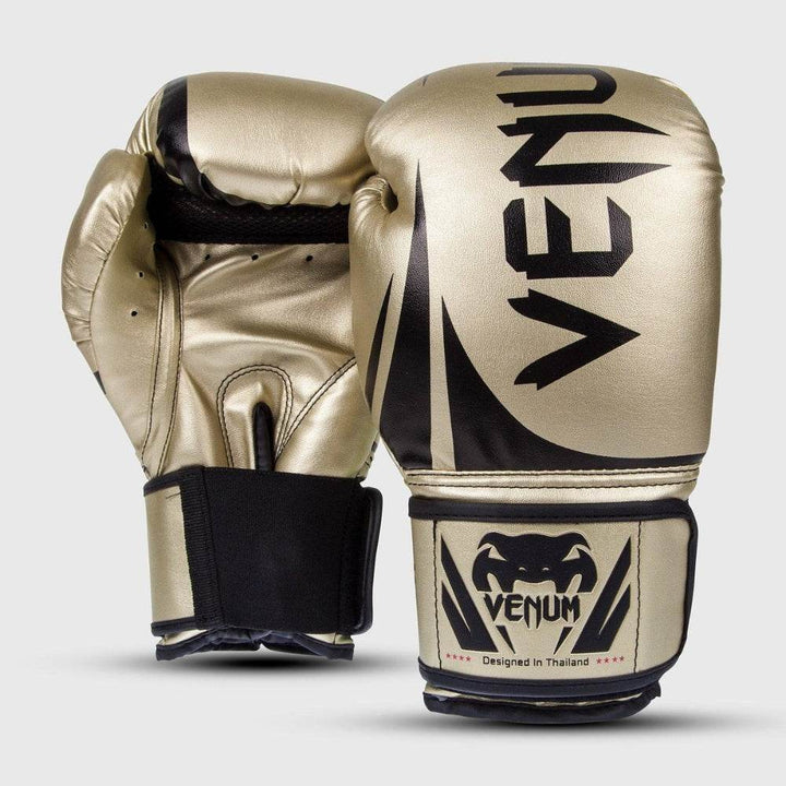 Front and back view of Venum Challenger 2.0 boxing gloves in gold with black accents, featuring the Venum logo on the striking surface and wrist strap.