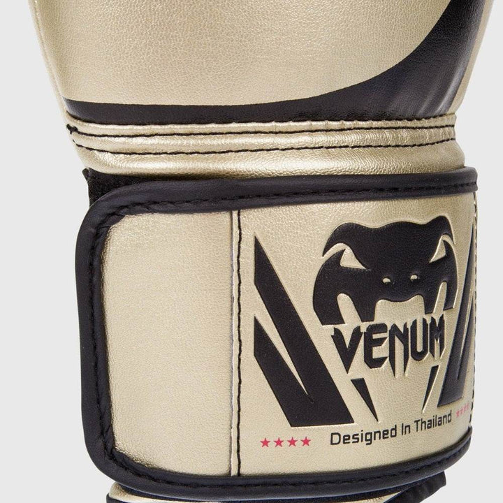 Close-up of the wrist strap showcasing the black Venum snake logo, “Designed in Thailand” inscription, and subtle star accents in red.