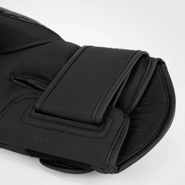 Close-up of the black wrist strap and velcro closure on the Venum Challenger 4.0 boxing glove, featuring “ADRENALINE INSIDE” text embossed near the base.
