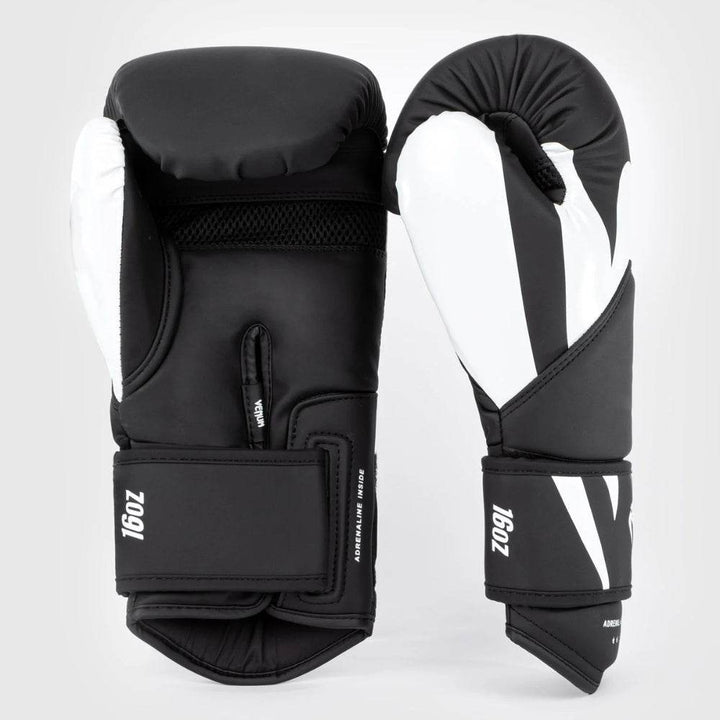 Side-by-side view of Venum Challenger 4.0 gloves showing the white palm side and the solid padding across the backhand in black and white.