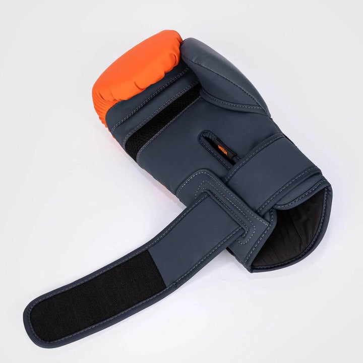 One glove with the wrist strap undone, showcasing the spacious cuff opening and hook-and-loop closure system.