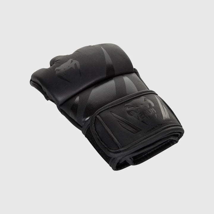 Folded glove highlighting reinforced layers and closed fist contour.