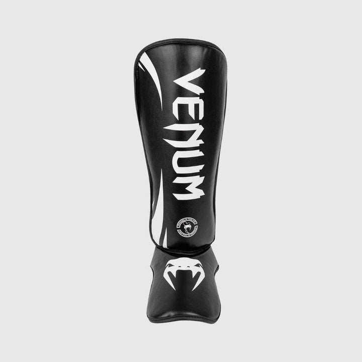 Straight front image of the Venum Challenger Shinguard highlighting the bold white "VENUM" logo vertically across the shin and fanged snake logo on the foot protector.