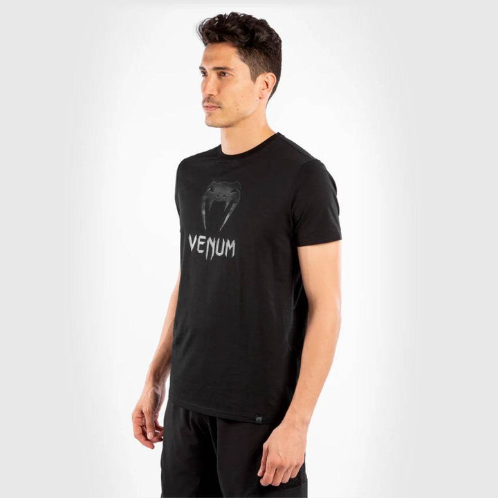 Man in side profile wearing the same t-shirt, showing the fit and sleeve length.
