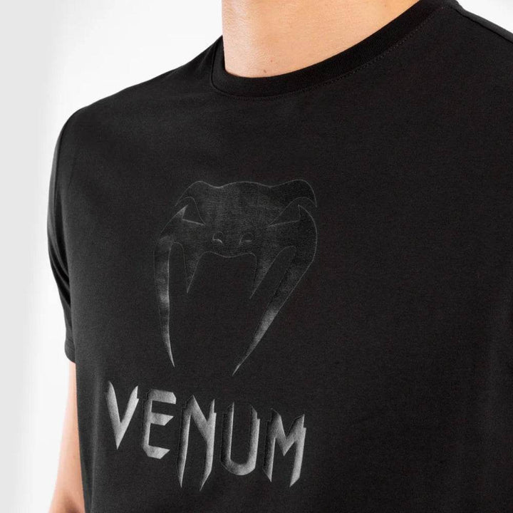 Close-up of the chest logo, showcasing the matte-black Venum snake emblem and text detail.